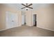 Spacious bedroom with carpet, ceiling fan, closet, and access to the ensuite bathroom at 1768 Oakbrook Nw Ln # 9, Kennesaw, GA 30152