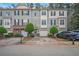 Attractive townhome showcasing the front exterior with an attached garage and lush landscaping at 1768 Oakbrook Nw Ln # 9, Kennesaw, GA 30152