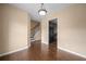 Hallway with hardwood flooring, offering seamless access to the staircase and the kitchen at 1768 Oakbrook Nw Ln # 9, Kennesaw, GA 30152