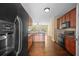 Modern kitchen with sleek appliances, granite countertops, and access to the living area at 1768 Oakbrook Nw Ln # 9, Kennesaw, GA 30152