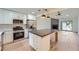 Open-concept kitchen with stainless steel appliances, island with breakfast bar, and modern lighting at 2027 Jebs Nw Ct, Kennesaw, GA 30144