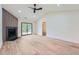 Bright living room features a fireplace, vaulted ceiling, and sliding glass door to the backyard at 2027 Jebs Nw Ct, Kennesaw, GA 30144