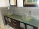 Bathroom vanity with double glass vessel sinks and dark wood cabinets, offering a modern design at 4125 Fastnet Lane, Duluth, GA 30096