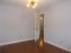 Bedroom with hardwood flooring, bright lighting, and a doorway leading to a hallway at 4125 Fastnet Lane, Duluth, GA 30096