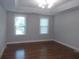 Bright bedroom with hardwood floors and plenty of natural light from the two windows at 4125 Fastnet Lane, Duluth, GA 30096