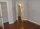 Neutral bedroom featuring wood floor, closet and hallway access at 4125 Fastnet Lane, Duluth, GA 30096