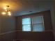 Neutral bedroom featuring two windows and a ceiling light fixture at 4125 Fastnet Lane, Duluth, GA 30096