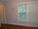 Neutral bedroom featuring a window, wood floor and white trim at 4125 Fastnet Lane, Duluth, GA 30096