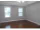 Bright bedroom with hardwood floors and plenty of natural light from the two windows at 4125 Fastnet Lane, Duluth, GA 30096