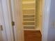 Walk-in closet featuring custom shelving and hardwood floors, providing ample storage space at 4125 Fastnet Lane, Duluth, GA 30096