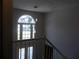 Bright entryway with a two-story foyer, large arched window, and modern pendant lighting at 4125 Fastnet Lane, Duluth, GA 30096