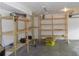 Spacious garage featuring ample storage with newly installed wooden shelving units at 4125 Fastnet Lane, Duluth, GA 30096