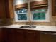 A kitchen featuring countertops, stainless steel sink, tile backsplash, and natural light at 4125 Fastnet Lane, Duluth, GA 30096