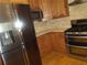 A modern kitchen featuring stainless steel appliances, including a range and refrigerator at 4125 Fastnet Lane, Duluth, GA 30096