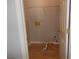 A compact laundry room with laminate wood flooring featuring essential hookups and shelving at 4125 Fastnet Lane, Duluth, GA 30096