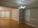 An open living area with wood floors, a modern light fixture, and ample natural light at 4125 Fastnet Lane, Duluth, GA 30096