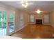An open living room with hardwood floors, fireplace, and access to outdoor deck at 4125 Fastnet Lane, Duluth, GA 30096