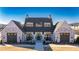 Charming community clubhouse with a brick facade, rocking chairs, and ample parking for neighborhood gatherings at 551 Pearl St, Cumming, GA 30040