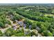 High-angle shot displays the house's setting near a golf course, surrounded by verdant foliage at 10119 Azalea Dr, Covington, GA 30014