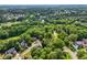 Panoramic aerial view featuring homes nestled amidst lush landscaping, and close proximity to golf course at 10119 Azalea Dr, Covington, GA 30014