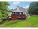 Backyard featuring a deck with a gazebo, patio furniture, and lush green space at 10119 Azalea Dr, Covington, GA 30014