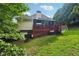 Spacious backyard with a red patio featuring a grill, perfect for outdoor entertaining at 10119 Azalea Dr, Covington, GA 30014