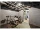 Unfinished basement area featuring exposed ceiling, gray walls, and workout equipment at 10119 Azalea Dr, Covington, GA 30014