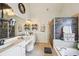 This bathroom features a walk-in shower, soaking tub, and double sink vanity with makeup area at 10119 Azalea Dr, Covington, GA 30014