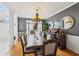 A formal dining area has a large wooden table, gray walls, and an ornate chandelier at 10119 Azalea Dr, Covington, GA 30014