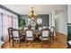 An elegant dining room features hardwood floors, a decorative chandelier, and plenty of natural light at 10119 Azalea Dr, Covington, GA 30014