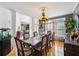 The dining room showcases a large table, hardwood floors, and access to the living room at 10119 Azalea Dr, Covington, GA 30014