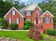 Beautiful red brick home with manicured lawn and traditional architectural details at 10119 Azalea Dr, Covington, GA 30014