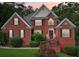 Charming two-story brick home with a well-manicured lawn and inviting front porch at 10119 Azalea Dr, Covington, GA 30014
