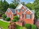 Stately red brick home with well-kept lawn and a inviting front entrance at 10119 Azalea Dr, Covington, GA 30014