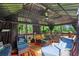 Outdoor gazebo featuring lounge seating, dining table, fire pit, and a ceiling fan at 10119 Azalea Dr, Covington, GA 30014