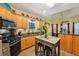 Kitchen featuring wooden cabinets, granite countertops, stainless appliances, and an island with seating at 10119 Azalea Dr, Covington, GA 30014