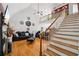 Bright living room with hardwood floors, fireplace and comfortable seating and stylish staircase at 10119 Azalea Dr, Covington, GA 30014