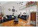 Bright living room featuring hardwood floors, high ceilings, and comfortable leather seating at 10119 Azalea Dr, Covington, GA 30014