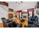 Bright living room featuring hardwood floors, a fireplace, and comfortable leather seating at 10119 Azalea Dr, Covington, GA 30014