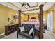 This main bedroom features a tray ceiling, a ceiling fan, a seating area, and an ensuite at 10119 Azalea Dr, Covington, GA 30014