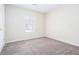 Bright bedroom with plush carpeting and natural light from a window, creating a peaceful and inviting space at 1049 Braddock Cir, Woodstock, GA 30189