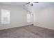 Neutral bedroom with carpet, ceiling fan, high ceiling and windows at 1049 Braddock Cir, Woodstock, GA 30189