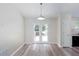 Bright dining area with stylish floors, access to a deck, and views into the kitchen, perfect for entertaining at 1049 Braddock Cir, Woodstock, GA 30189