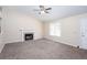 Inviting living room with plush carpeting, a fireplace, and natural light, creating a comfortable and welcoming space at 1049 Braddock Cir, Woodstock, GA 30189