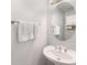Stylish powder room with a pedestal sink, an oval mirror, and a brushed nickel towel rack at 1403 Ashford Creek Ne Cir, Atlanta, GA 30319