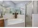 Bright bathroom featuring a garden tub with tile surround and a separate glass enclosed shower at 1403 Ashford Creek Ne Cir, Atlanta, GA 30319