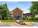 Inviting clubhouse exterior featuring beautiful landscaping and a brick facade with a covered entrance at 1403 Ashford Creek Ne Cir, Atlanta, GA 30319