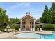 Community pool area with a building and ample seating for residents to enjoy at 1403 Ashford Creek Ne Cir, Atlanta, GA 30319