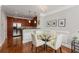 Cozy dining area featuring hardwood floors, modern lighting, and a glass-top table with seating at 1403 Ashford Creek Ne Cir, Atlanta, GA 30319