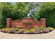 The Ashford Creek Townhomes entrance is beautifully landscaped and marked with a brick sign at 1403 Ashford Creek Ne Cir, Atlanta, GA 30319
